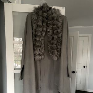 Long sweater with faux fur trim.